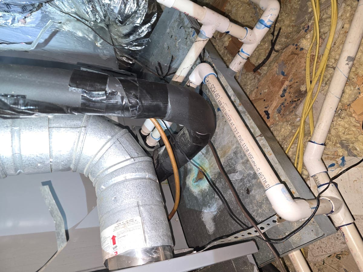 Condensate plumbing and PVC lines in attic during HVAC service in Irving TX